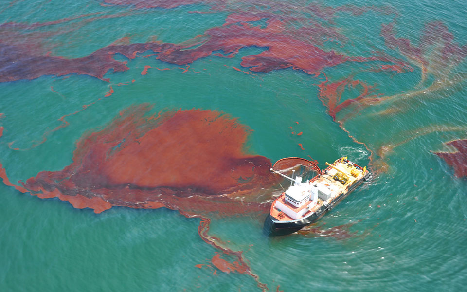 A "vessel of opportunity" skims oil spilled after the Deepwater Horizon well blowout in the Gulf of Mexico in April 2010.