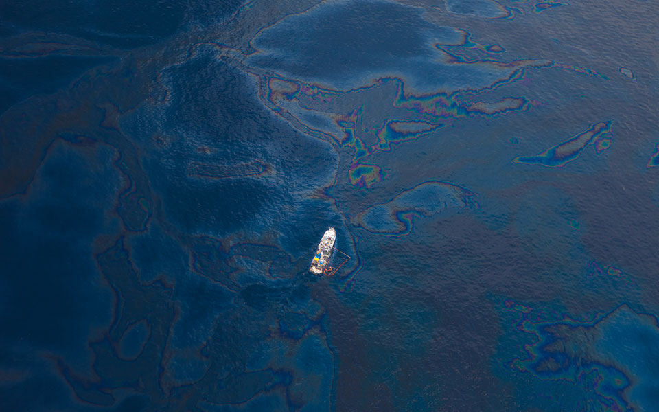 A ship floats in a sea of spilled oil in the Gulf of Mexico after the BP Deepwater Horizon oil spill disaster.