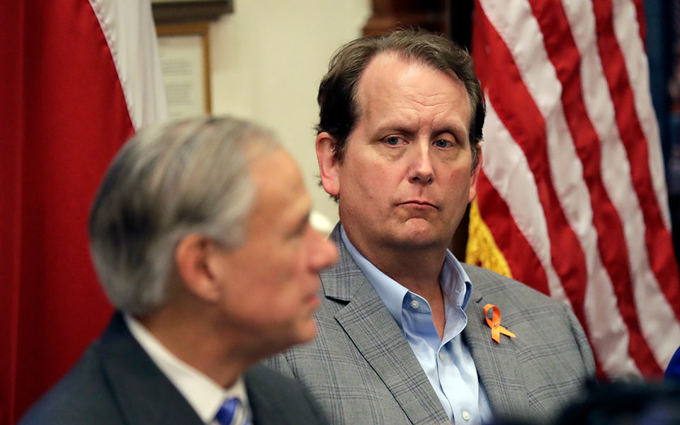 Ed Scruggs, right, listens to Texas Governor Greg Abbott, left, during a roundtable discussion to address safety and security at Texas schools in the wake of the shooting at Santa Fe High School in 2018.