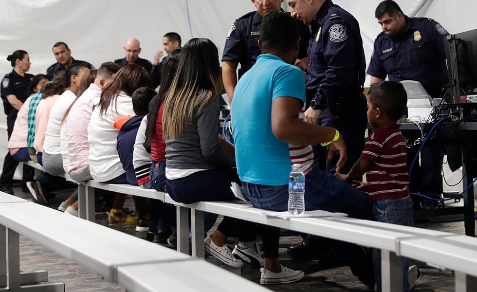 Migrants who are applying for asylum in the United States go through a processing area at a new tent courtroom at the Migration Protection Protocols Immigration Hearing Facility, Tuesday, Sept. 17, 2019, in Laredo, Texas. (AP Photo/Eric Gay)