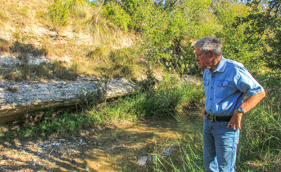 Andrew Sansom at the banks of the Williams Creek on September 13, 2019. He says that if the pipeline were to leak condensed gas where it crosses this stream, the contaminants would flow into the Pedernales River, which supplies 23 percent of Austin’s drinking water.