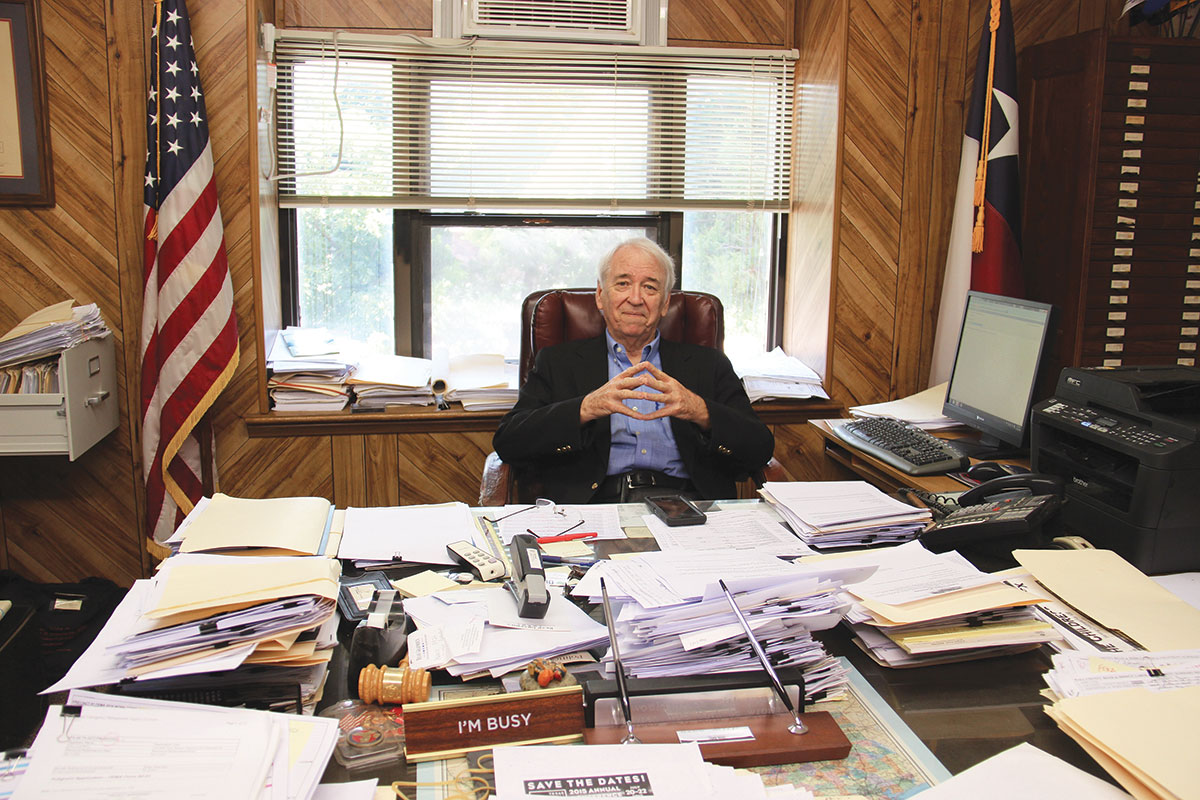 Hall County Judge Ray Powell keeps a folder of news clippings on his desk with examples of other Texas communities that have brought back health care.
