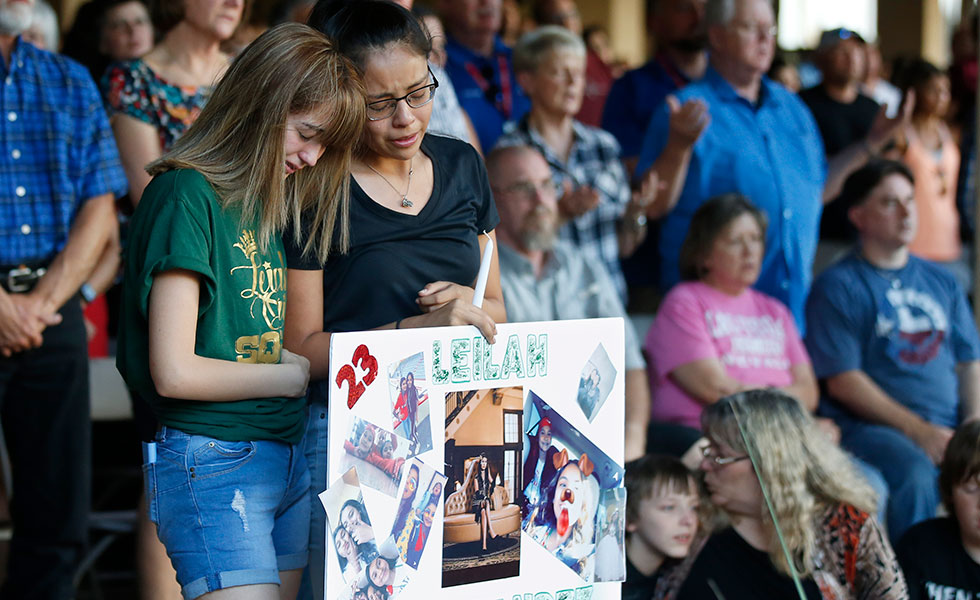 High school students Celeste Lujan, left, and Yasmin Natera, right, mourn their friend, Leilah Hernandez, one of the victims of the August 31 shooting in Odessa.
