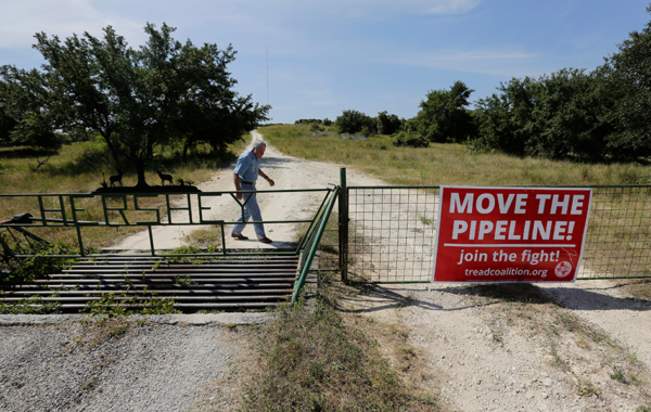 Andy Sansom walks on his property where a proposed new natural gas pipeline would pass through his ranch in the Texas Hill Country near Stonewall, Texas Friday, Aug. 2, 2019. A proposed pipeline is a 430-mile, $2 billion natural gas expressway that pipeline giant Kinder Morgan has mapped from the booming West Texas oil patch to Houston. (AP Photo/Eric Gay)