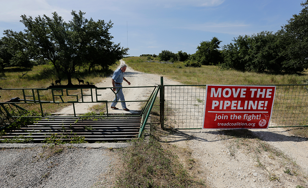 Andy Sansom walks on his property where a proposed new natural gas pipeline would pass through his ranch in the Texas Hill Country near Stonewall, Texas Friday, Aug. 2, 2019. A proposed pipeline is a 430-mile, $2 billion natural gas expressway that pipeline giant Kinder Morgan has mapped from the booming West Texas oil patch to Houston. (AP Photo/Eric Gay)