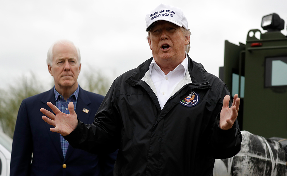 President Donald Trump speaks as he tours the U.S. border with Mexico Thursday, Jan. 10, 2019, in McAllen, Texas, as Sen. John Cornyn, R-Texas, listens. (AP Photo/ Evan Vucci)