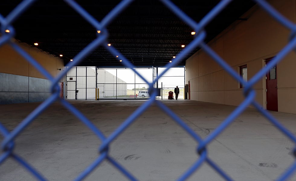 A secured entryway is seen at the Karnes County Residential Center in Karnes City, Texas on Thursday, July 31, 2014. Federal officials gave a tour of the South Texas immigration detention facility that has been retooled to house adults with children who have been apprehended at the border. (AP Photo/Eric Gay)