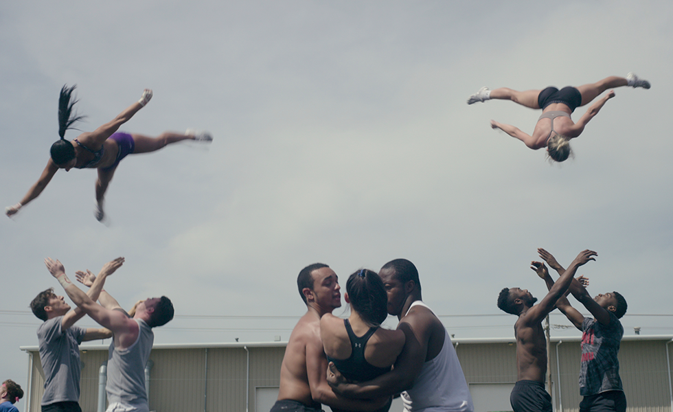 In one scene from the documentary series, groups of three toss members of the squad into the air.