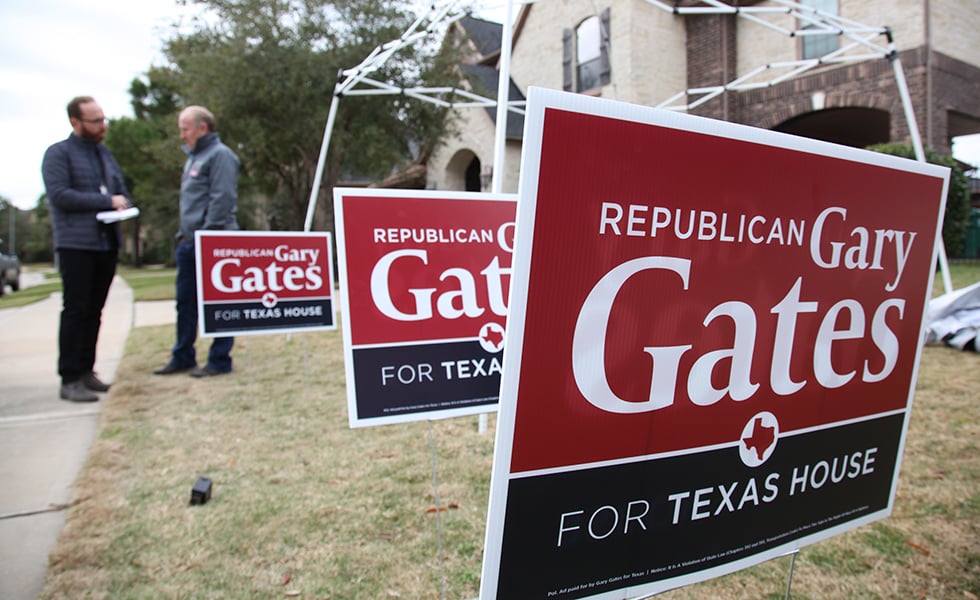 In this January 11, 2020 photoGary Gates, a Republican businessman running for a Texas state house seat up for special election in the suburbs west of Houston speaks in front of campaign signs placed on a volunteers lawn in Katy, Texas. Gates' opponent, Eliz Markowitz, is getting national endorsements from big name Democrats before voters go the polls on January 28. (AP Photo/ John L. Mone)