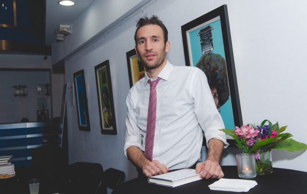 Alec Karakatsanis with his book 'Usual Cruelty.'