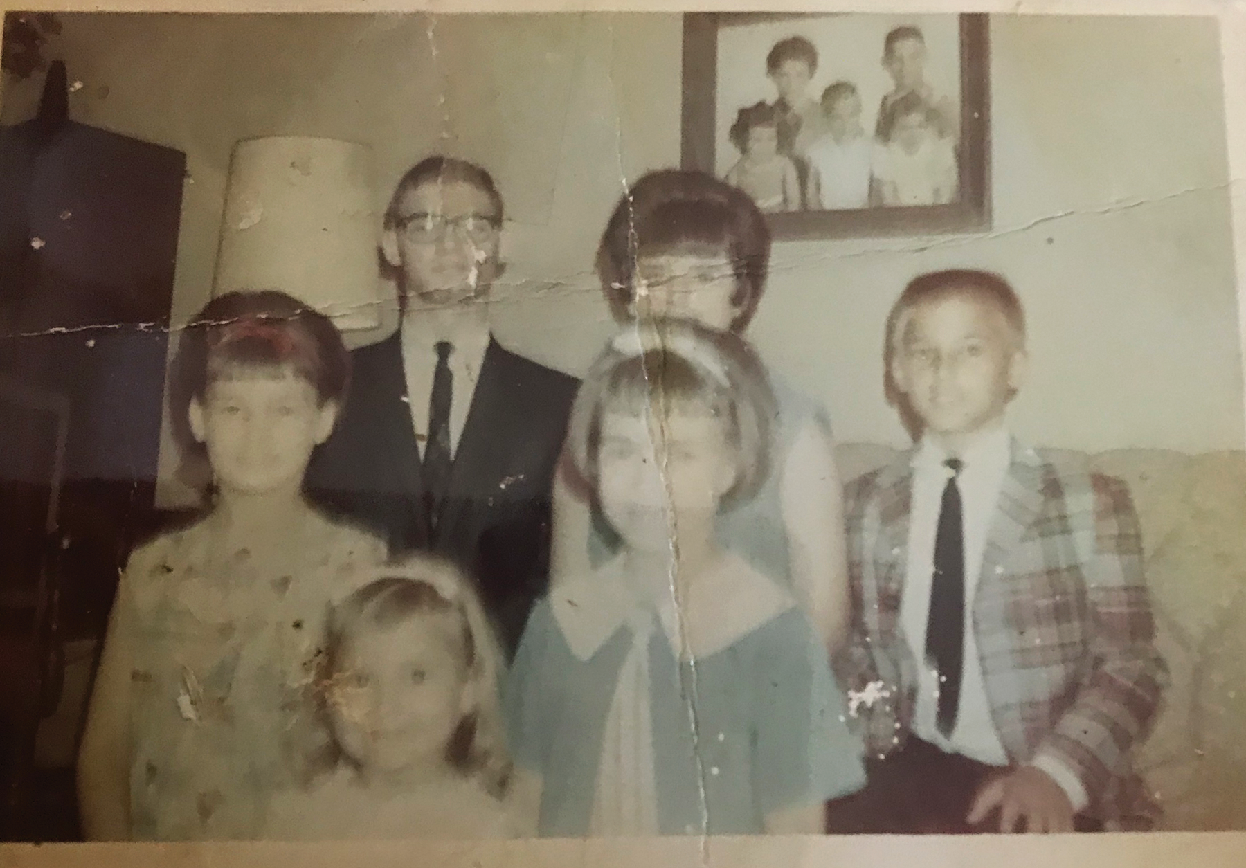 This family photo shows all six Gonsoulin siblings. Dianne is the youngest, pictured bottom left; Donna is in the center front, in a blue dress.