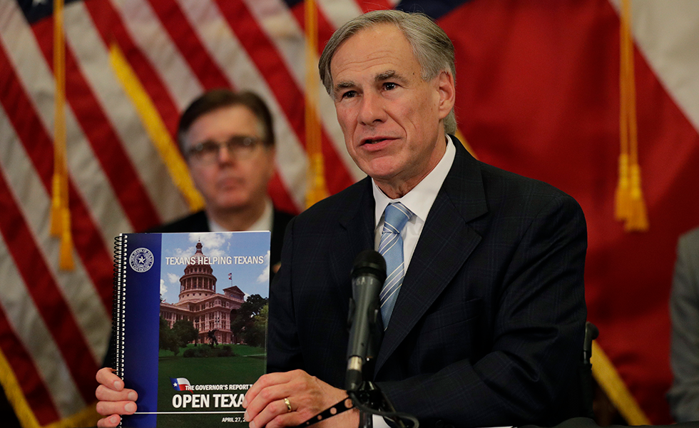 Texas Gov. Greg Abbott holds the Governor's Report to Reopen Texas book during a news conference where he announced he would relax some restrictions imposed on some businesses due to the COVID-19 pandemic, Monday, April 27, 2020, in Austin, Texas. (AP Photo/Eric Gay)