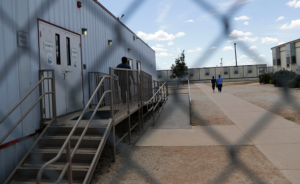 Immigrants seeking asylum walk at the ICE South Texas Family Residential Center, Friday, Aug. 23, 2019, in Dilley, Texas. U.S. Immigration and Customs Enforcement hosted a media tour of the center that houses families who are pending disposition of their immigration cases.(AP Photo/Eric Gay)