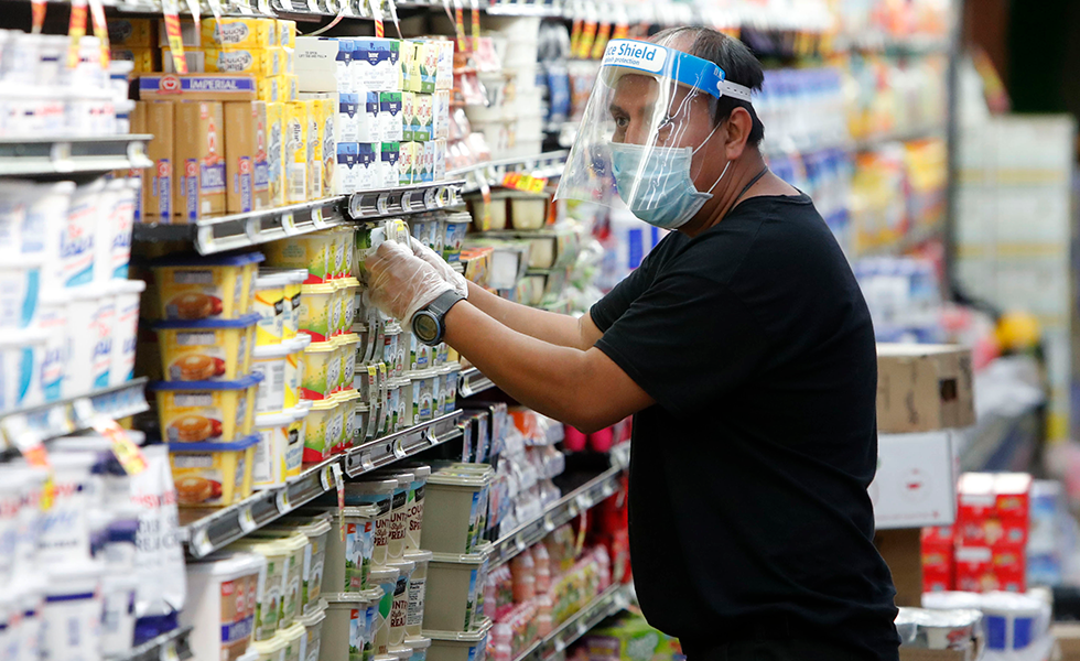 Amid concerns of the spread of COVID-19, a worker restocks products at a grocery store in Dallas, Wednesday, April 29, 2020. (AP Photo/LM Otero)