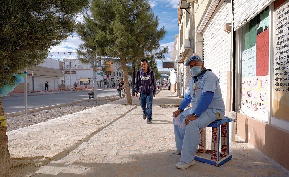 A dentist sits outside of his practice in central Juárez. Although medical facilities have not been ordered to close, they’ve taken a hit, as they rely heavily on uninsured American customers.