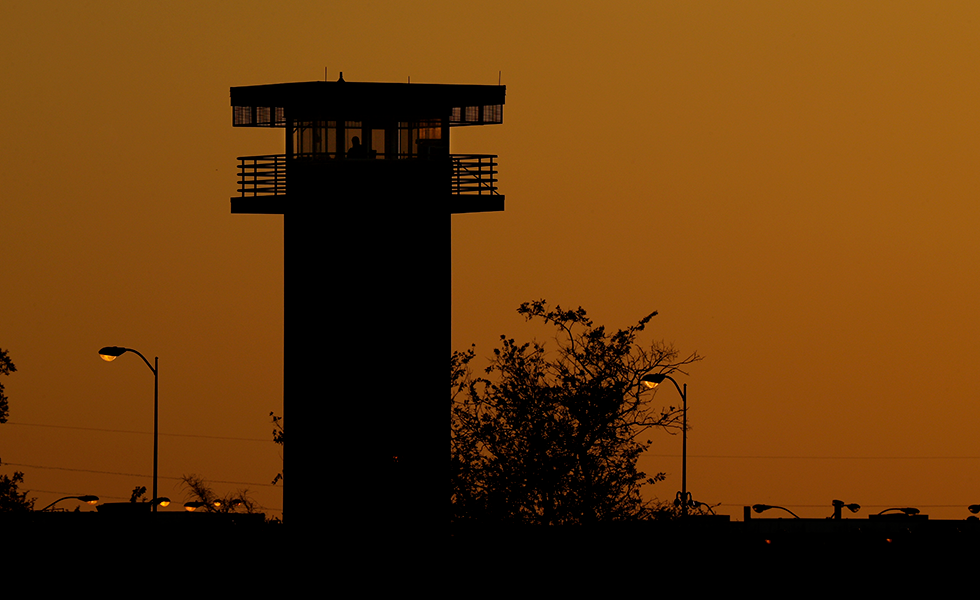 Part of the Texas Department of Criminal Justice's William G. McConnell Unit in Beeville, Texas, stands at sunset Wednesday, April 15, 2020. More than 26,000 people have been locked down in 22 Texas prisons that are keeping prisoners in their cells in an effort to contain the coronavirus, according to the TDCJ's most recent numbers. The McConnell Unit is not one of the 22. (AP Photo/Eric Gay)