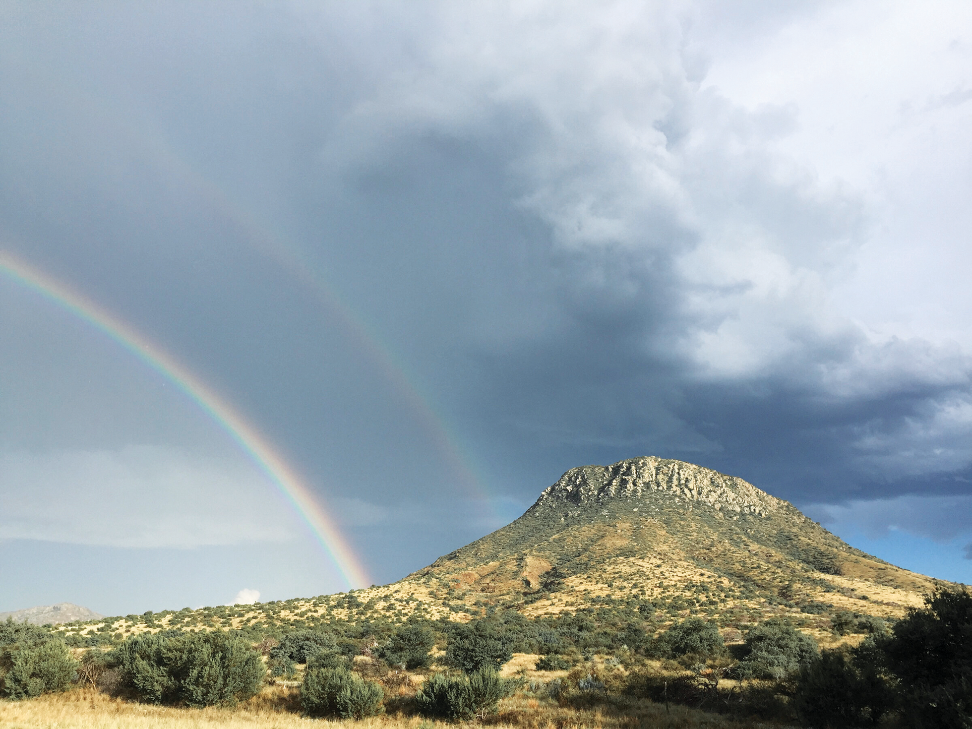 A double rainbow illuminates the sky at Paisano Pass between Alpine and Marfa.
