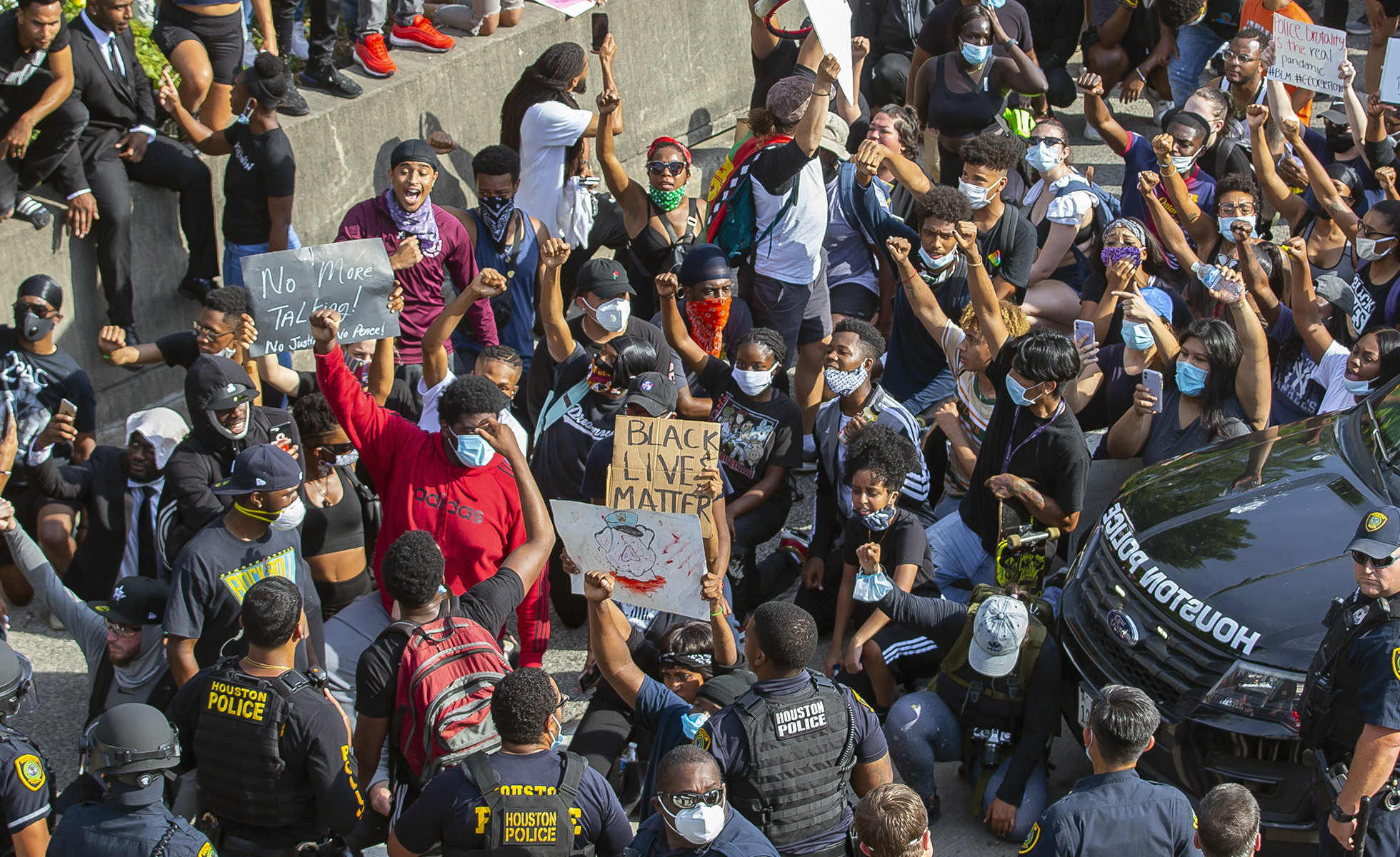 Protesters stop and chant "I can't breathe" as they march northbound on 288 just south of Tuam Street during a demonstration related to the death of George Floyd, a handcuffed black man who died Memorial Day while in the custody of the Minneapolis police, in Houston, Friday, May 29, 2020. (Mark Mulligan/Houston Chronicle via AP)