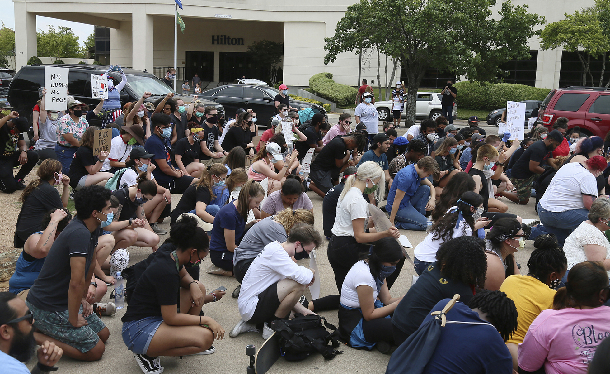 Protesters bow their heads during a local civil advocates rally in Waco, Texas, Sunday, May 31, 2020, near the Waco Suspension Bridge, to join in a peaceful protest after the death of George Floyd in Minneapolis last week. About 450 demonstrators chanted for racial equality, justice and the end of police brutality. (Rod Aydelotte/Waco Tribune Herald, via AP)