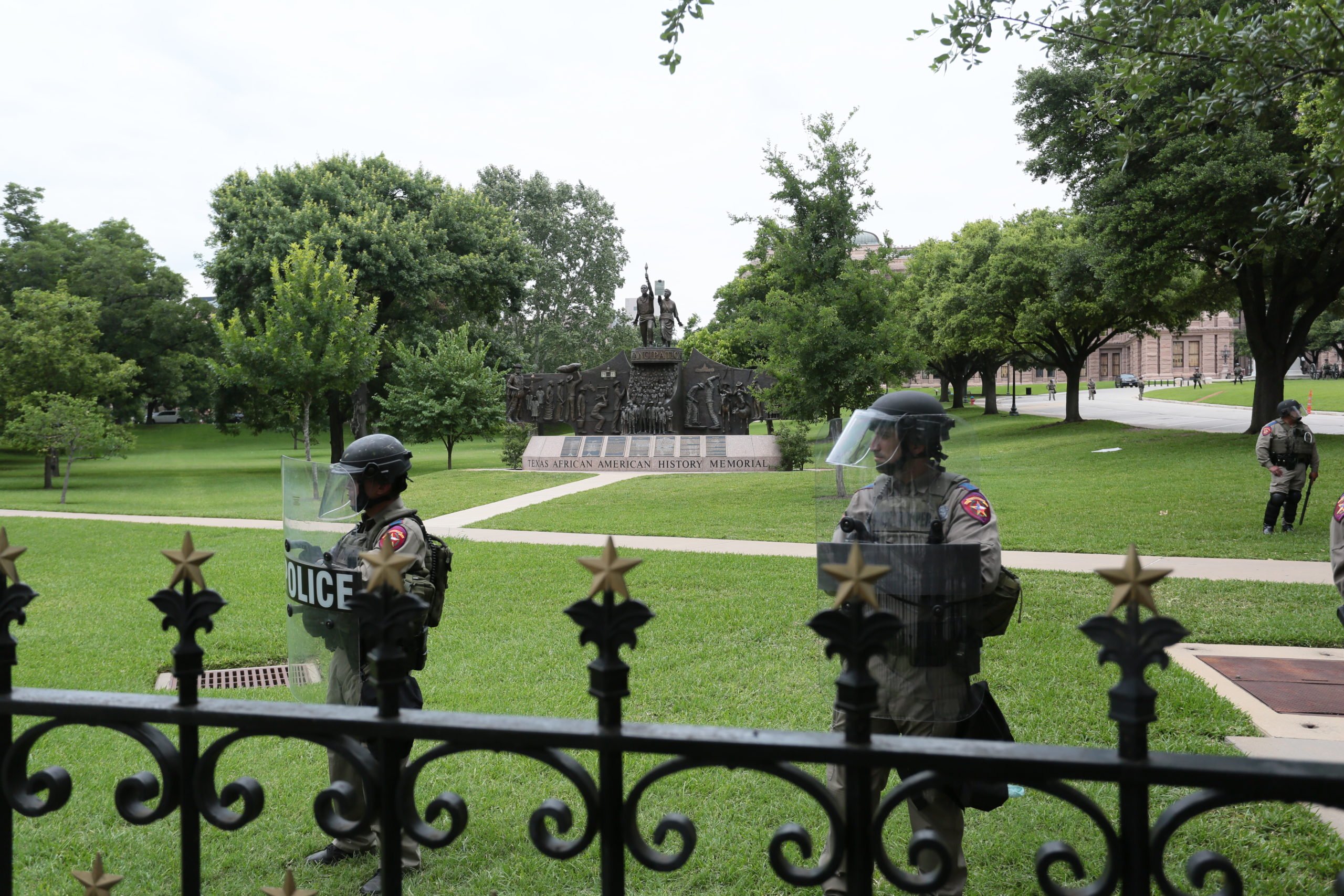 State troopers guard the South Lawn at the Texas Capitol on Sunday, May 31. The Texas African American History Memorial is prominent behind them. Several Confederate monuments adorn the lawn, as well.