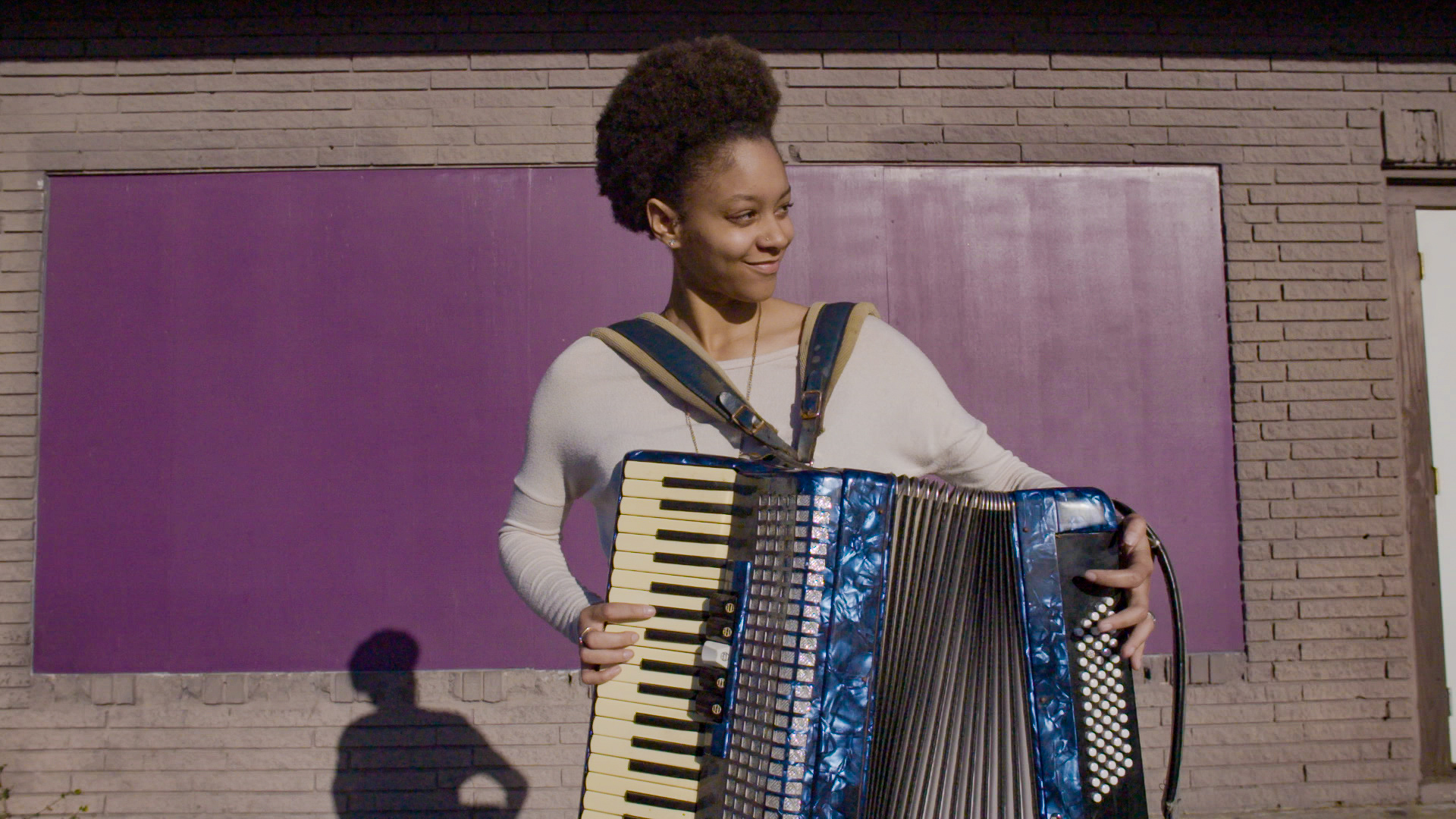 Alexis Jolivette plays an accordian.