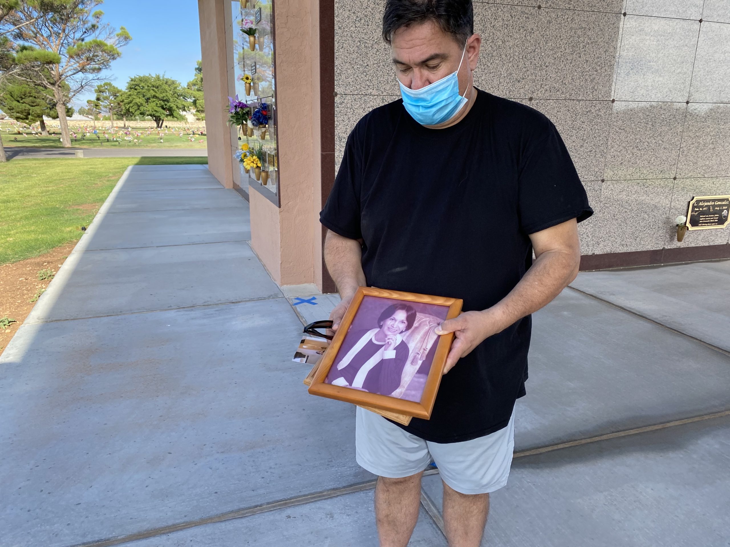 William Englisbee’s holds a photo of his 86-year-old mother, Angelina Maria Silva de Englisbee, at Evergreen Cemetery in El Paso. She was one of 23 victims killed August 3, 2019 during a mass shooting inside a Walmart.