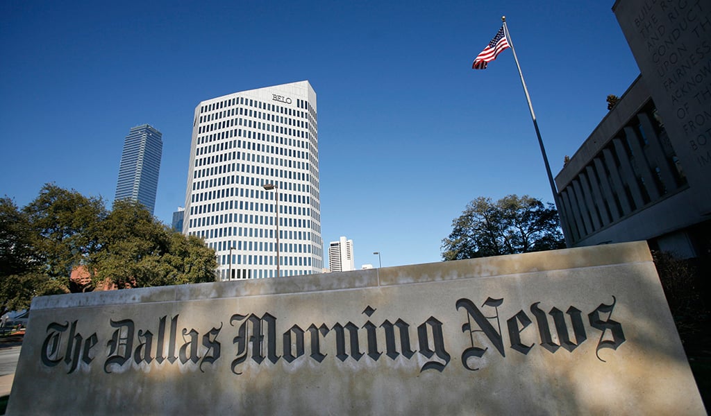 ** FILE ** A sign for The Dallas Morning News building is shown near the Belo Corp. headquarters building Tuesday, Feb. 6, 2007, in Dallas. Belo Corp. has announced Monday, Oct. 1, 2007, that it will spin off its newspaper division to create separate newspaper and television station companies. (AP Photo/Matt Slocum, File)