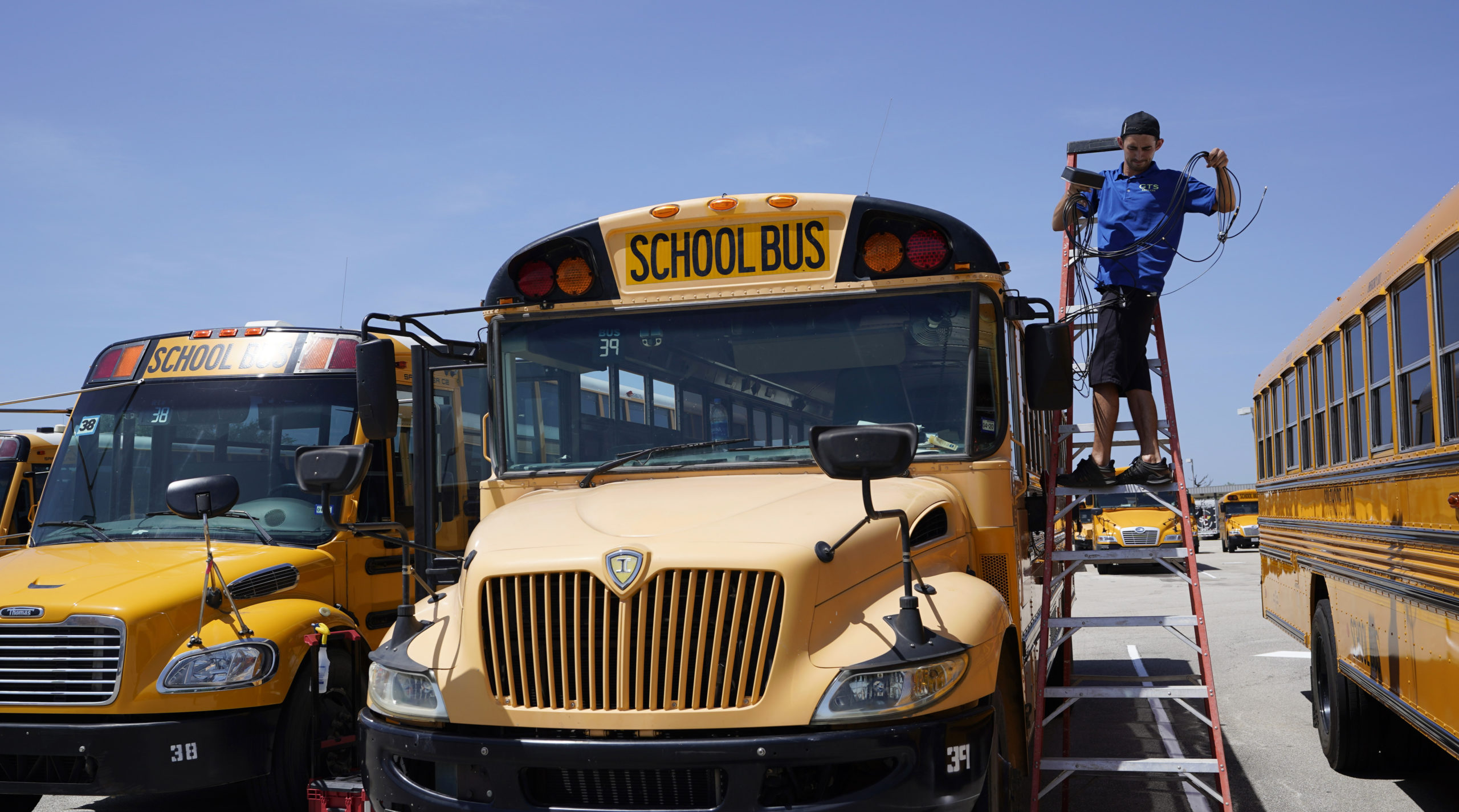 Spencer Hollers works to equip Southside Independent School District buses with wifi, Thursday, Aug. 13, 2020, in San Antonio. Southside will being the year with remote teaching and will place the wifi-equipped buses around the school district to help students without access to the internet. (AP Photo/Eric Gay)