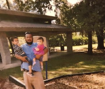 Hilder Lainez-Alvarez holding two of his five children.