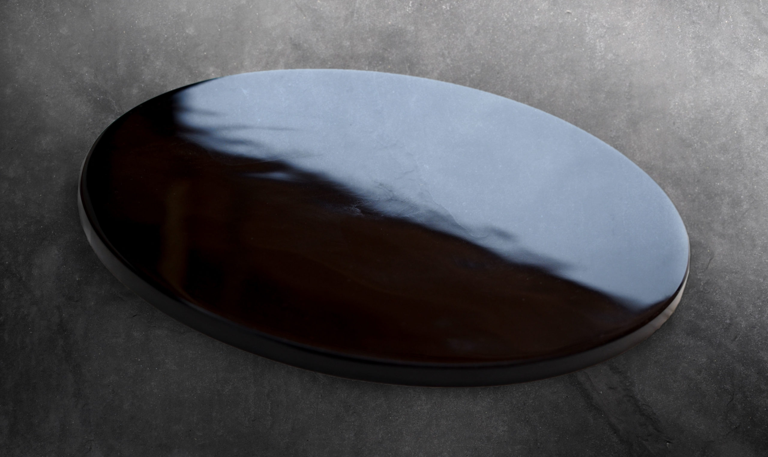 A piece of obsidian on a natural background.