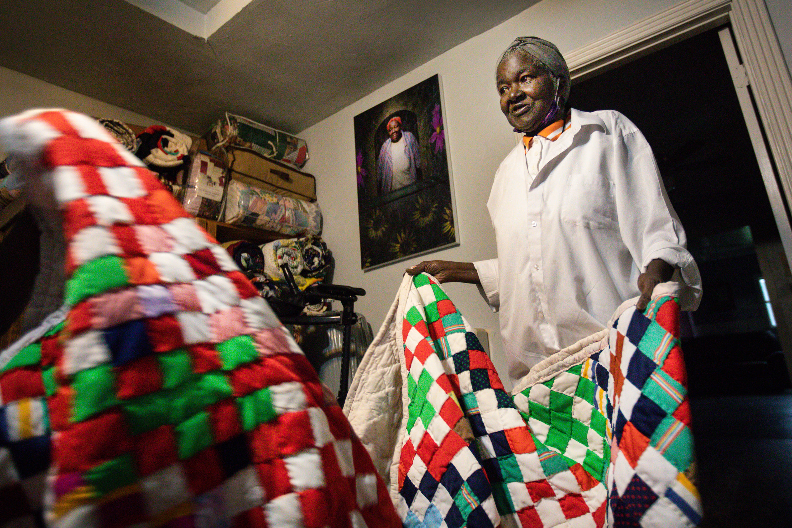 Mays, Brackens’ daughter, holds a quilt containing nine patch blocks made by her late grandmother Gladys Henry.