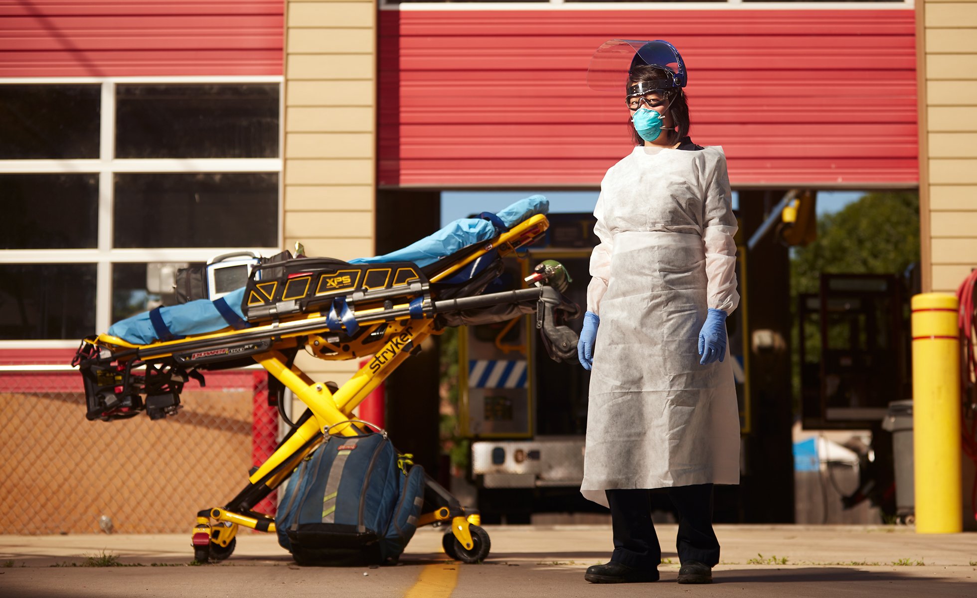 Selena Xie is a paramedic, intensive care nurse, and the president of the Austin EMS Association. She stands in full PPE at a medic station just east of Austin, in Travis County.