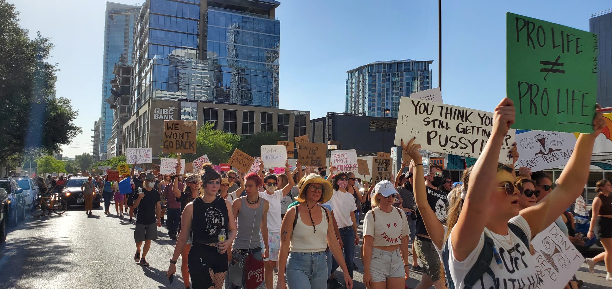 With signs like "Pro-Life does not equal Pro-Life" and "You Think You're Still Getting Pussy, That's Cute" marchers parade through downtown Austin, closely followed by Austin Police.