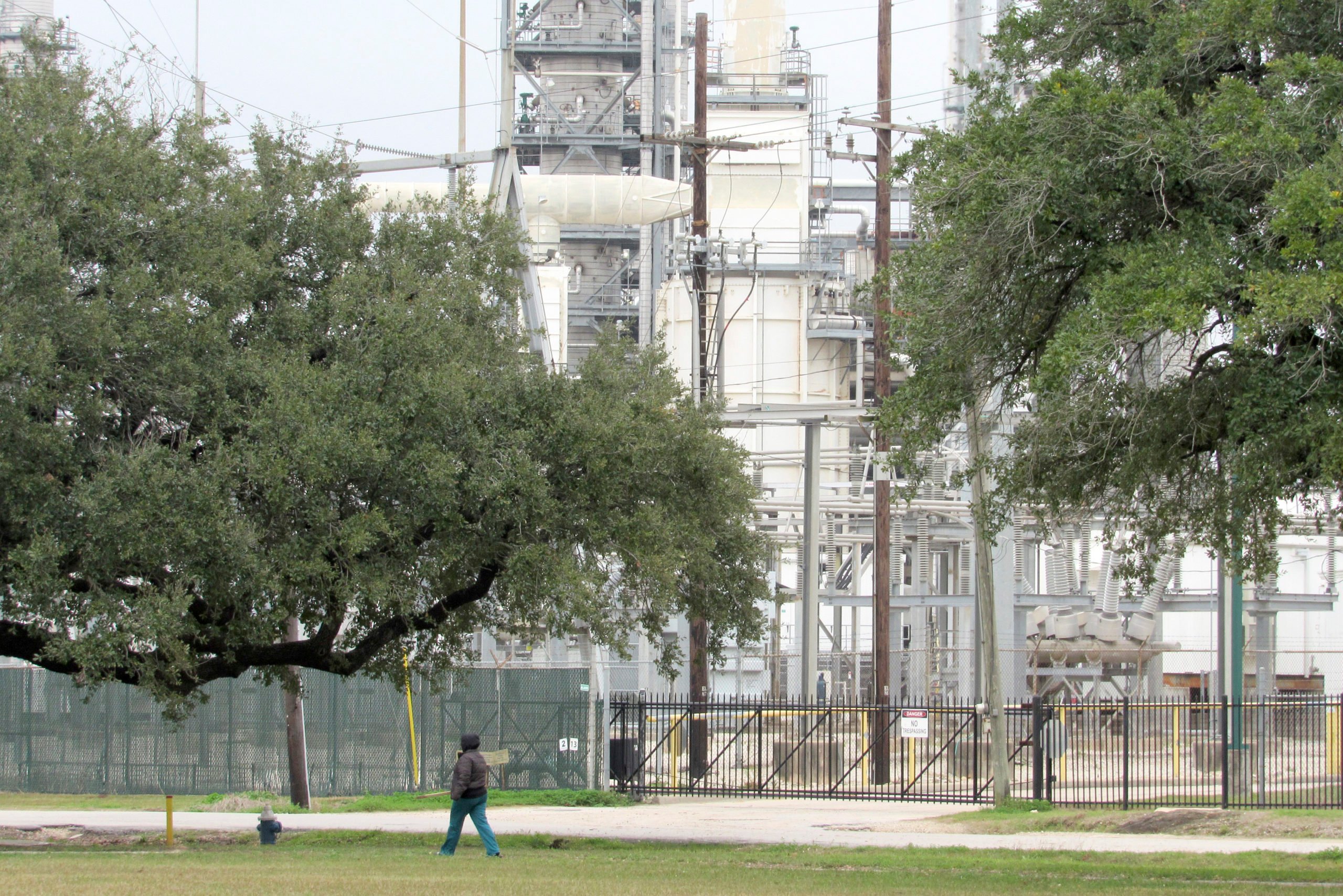 Houston resident Guadalupe Ortiz takes her daily walk at a city park located across the street from her home and a Valero oil refinery.