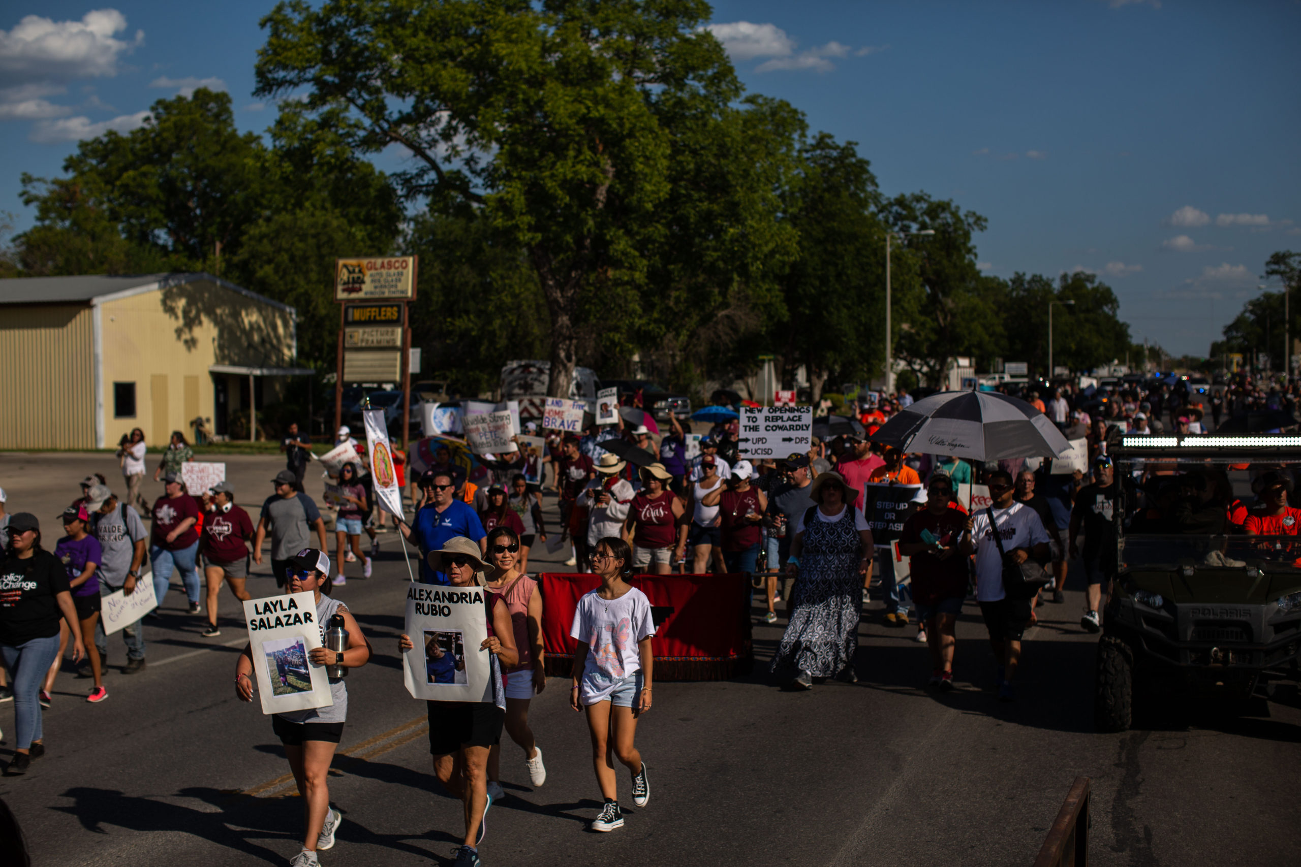 Hundreds of people march through the Uvalde streets under the hot Texas sun. In the lead are relatives of the victims, holding signs with their names and photos.