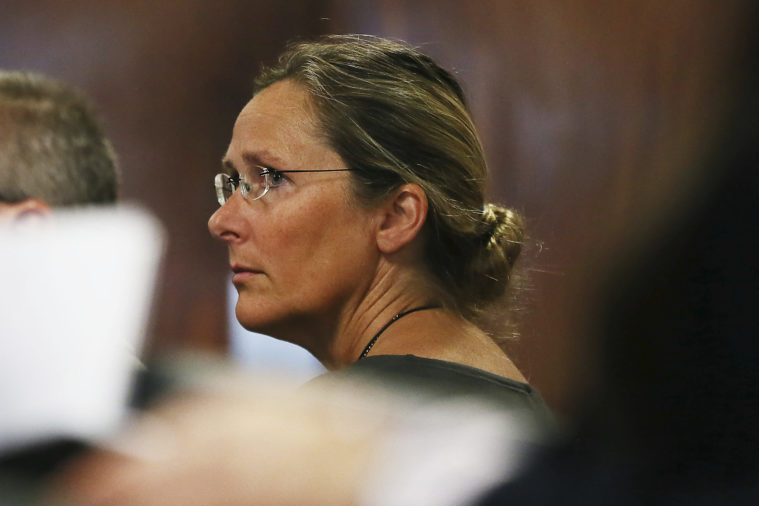 Scarlett Lewis, mother of 6-year-old Sandy Hook shooting victim Jesse Lewis, appears in court during the trial for Alex Jones. Seen in profile, lewis is a white woman, wearing glasses, with a very serious expression. Her hair is tied in a bun.