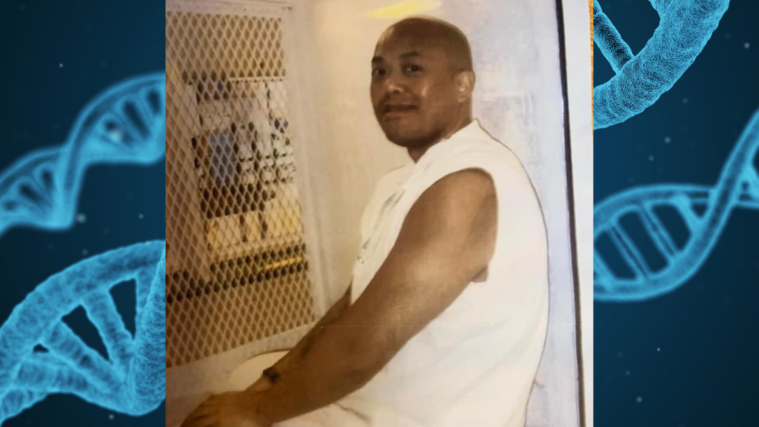 Kosoul Chanthakoummane, a bald Laotian man, sits inside a viewing window in a prison, wearing a sleeveless white top and white pants. Behind his photo, is an illustration of DNA molecules in their customary double-helix shape.