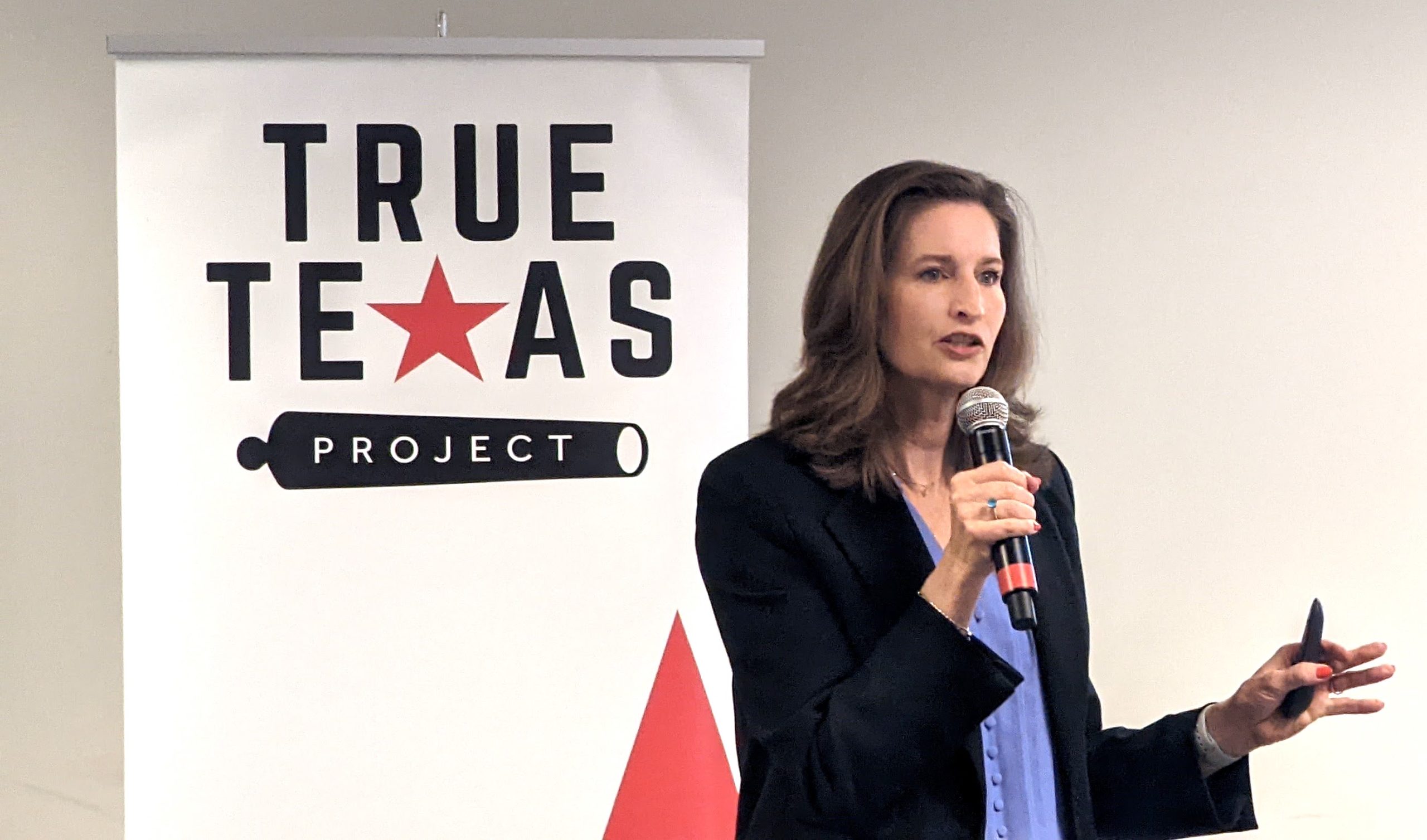 Margaret Byfield, executive director of American Stewards of Liberty, speaks into a microphone at a True Texas Project event.