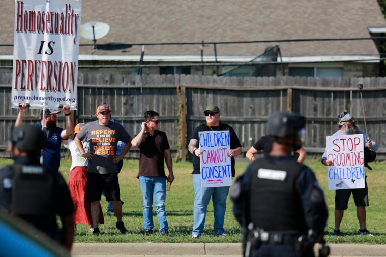 Right-wing protesters, many of whom subscribe to Christian nationalism, protest outside a family-friendly Pride event with sins calling homosexuality a sin or linking it to pedophilia.