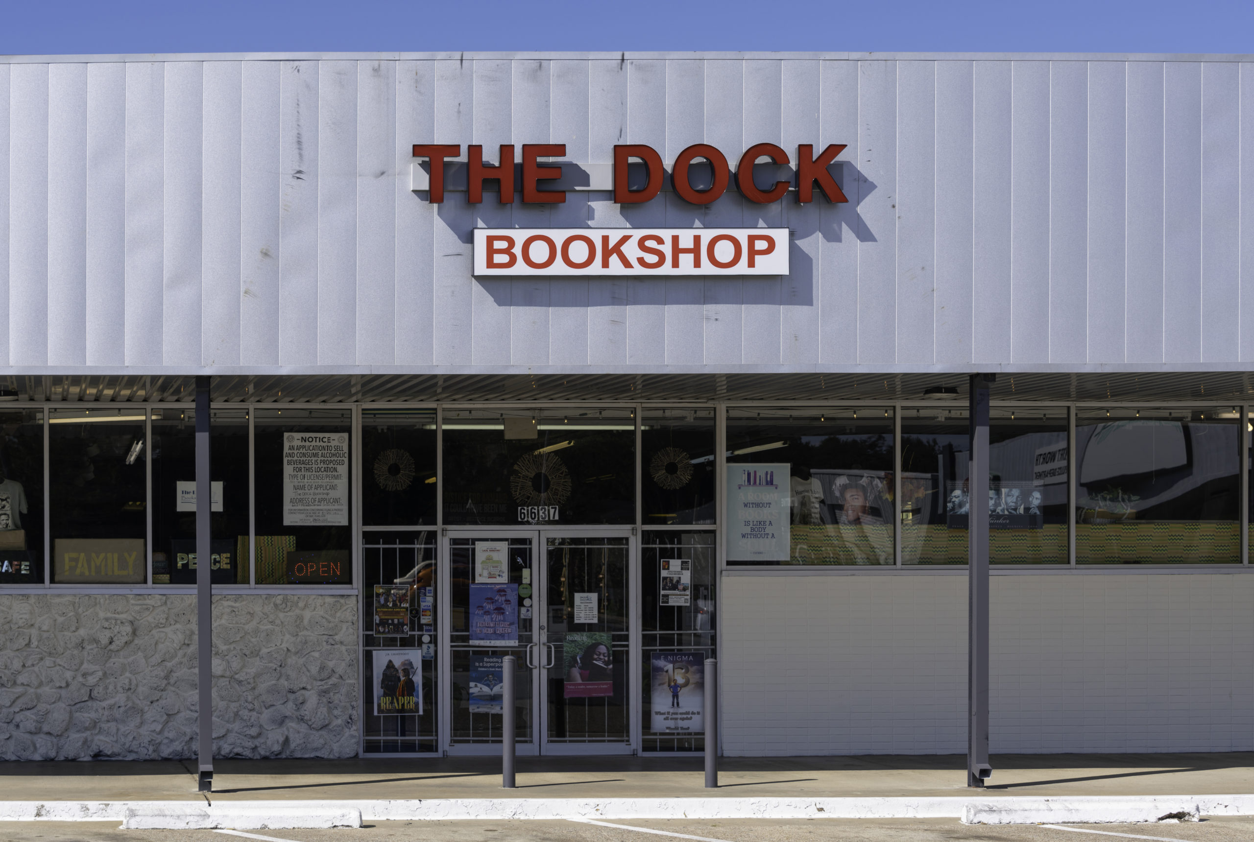 The Dock Bookshop is a strip mall-style store with welcoming signs in the windows with words like "safe," "family" and "peace."
