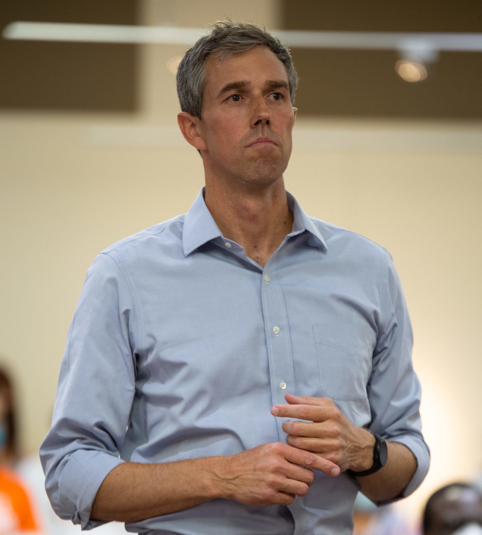 Beto O'Rourke, wearing a blue button-down, looks into the distance with a pensive expression as he fidgets with his hands. What's next for Texas Democrats after O'Rourke's defeat?