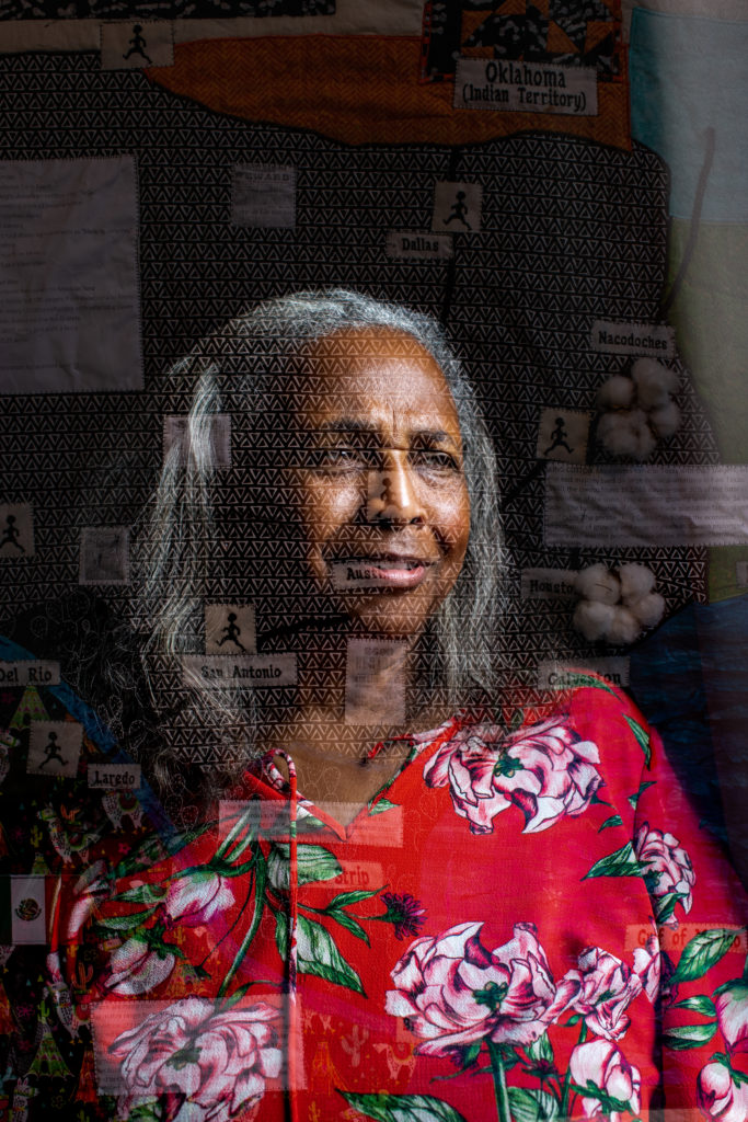 A Black woman in a red blouse, looking to the right of the camera. Superimposed on her is an image of a black and white quilt, shaped partly like the state of Texas.