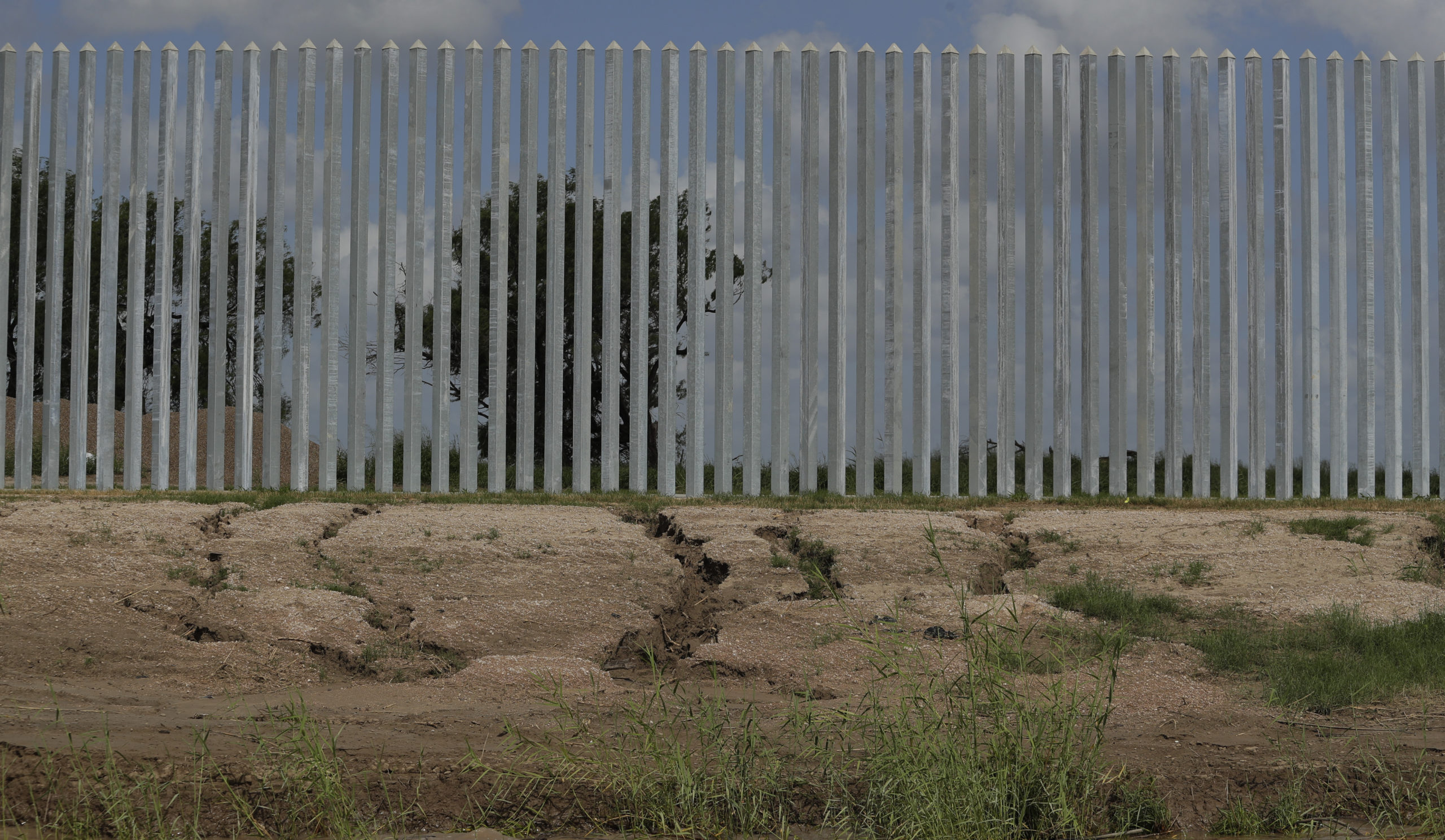 Erosion damage caused by Hurricane Hanna is seen along the Fisher border wall, a privately funded border fence, along the Rio Grande River near Mission, Texas.