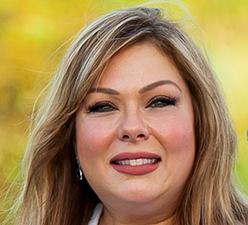 Texas State Board of Education member Julie Pickren is a white woman with dirty blonde hair, seen here wearing red lipstick.