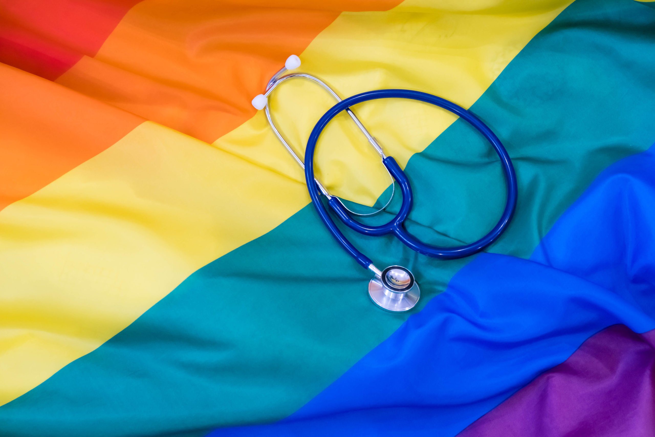 A rainbow Pride flag with a stethoscope on it.
