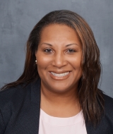 Texas State Board of Education member Evelyn Brooks is a BIPOC woman in a white shirt and black formal jacket.