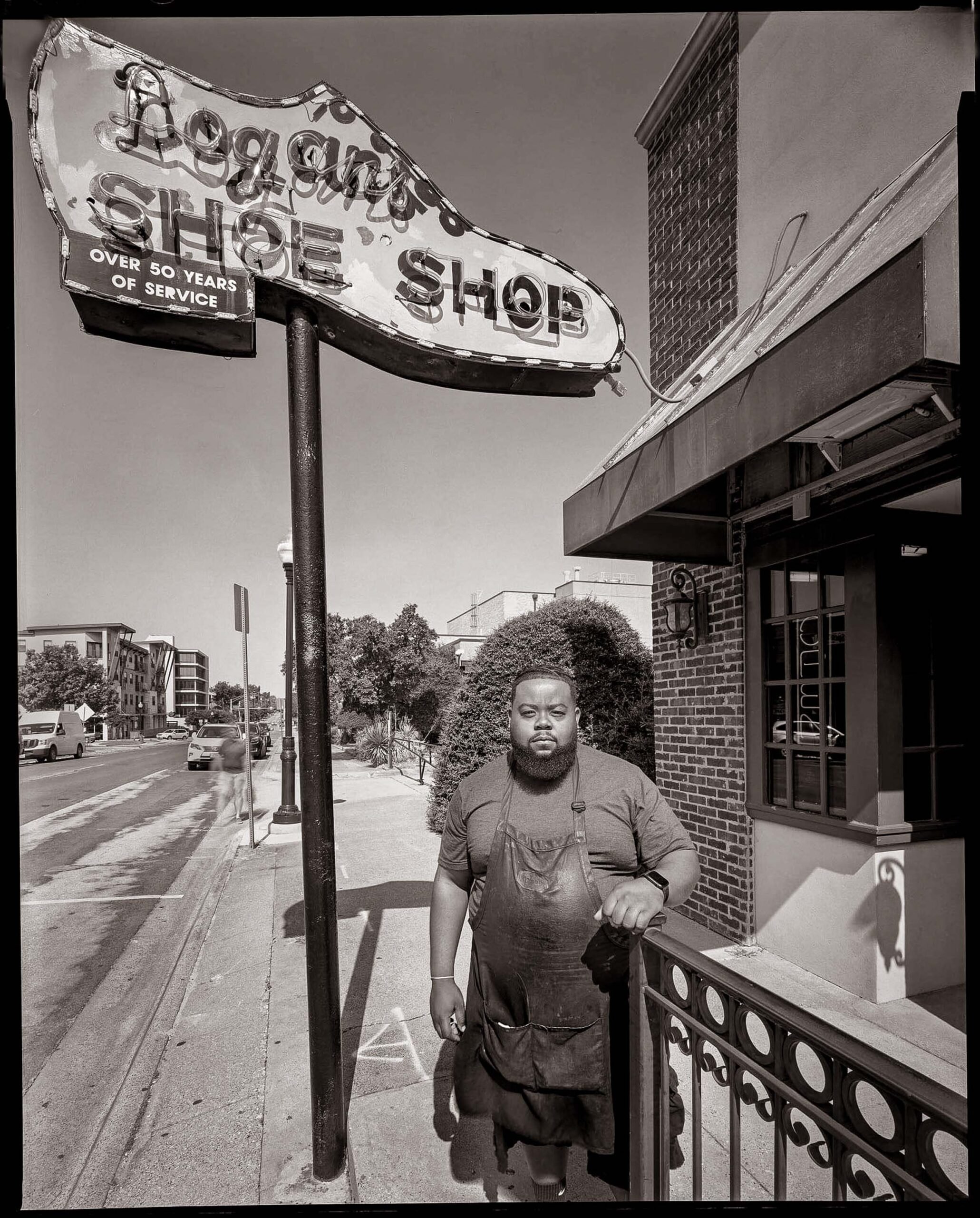 Christopher Jones works in the shoe repair shop owned by his grandmother, Dessie Jones, in Denton in 2019.