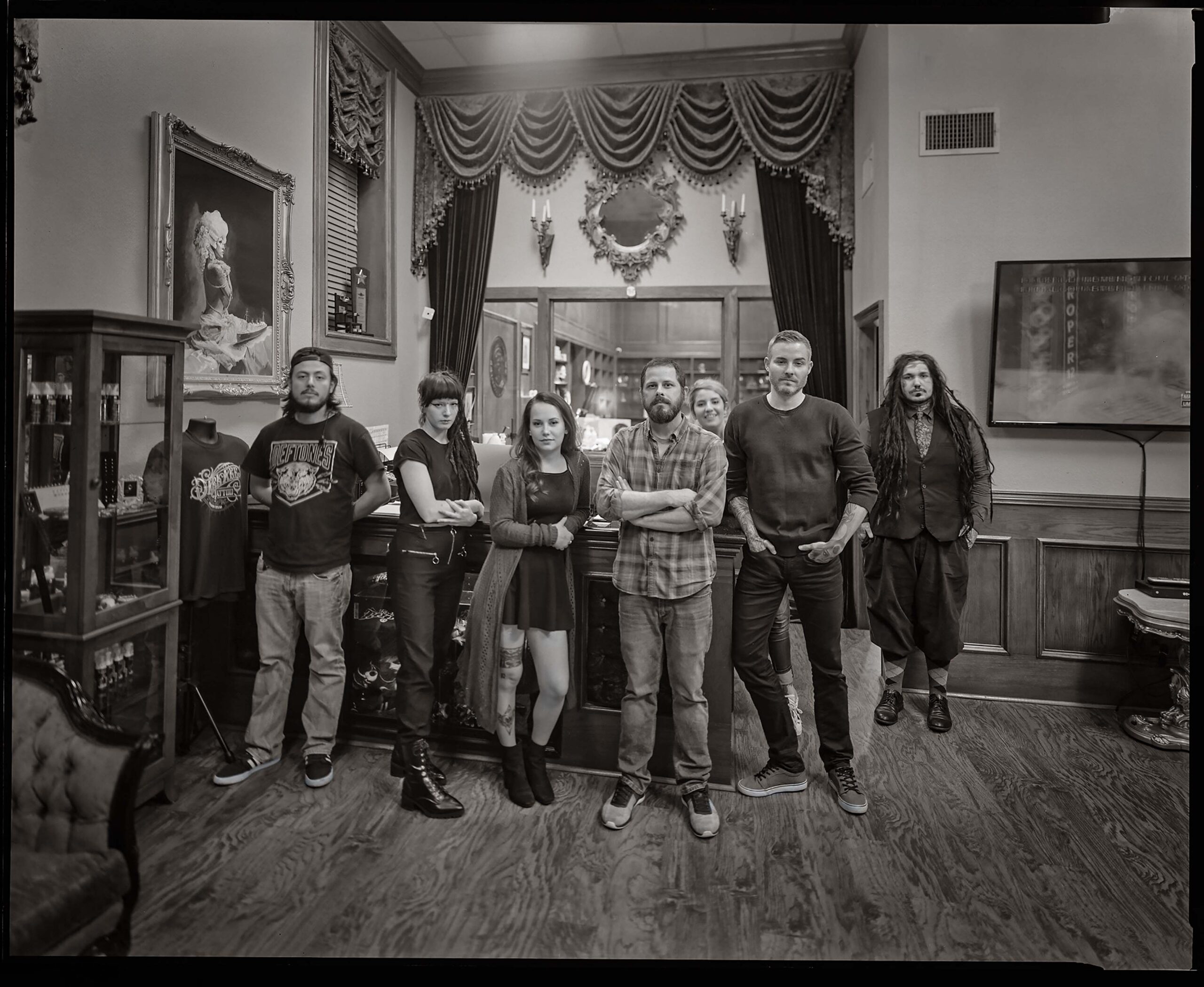 The crew at Denton’s Dark Age Tattoo Studio pauses in their work for this shot in 2019.