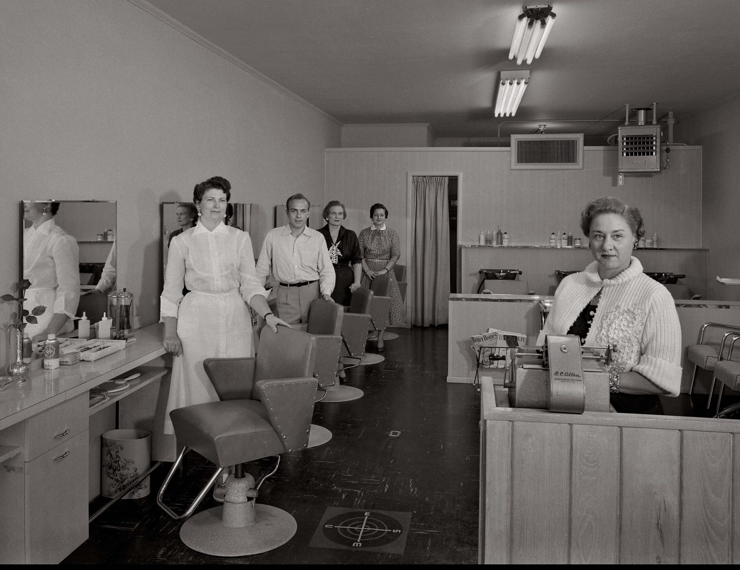 At the Westcliff Hair Salon in south Fort Worth in 1952, hairdressers line up at their work stations while a co-worker stands ready to check out customers.