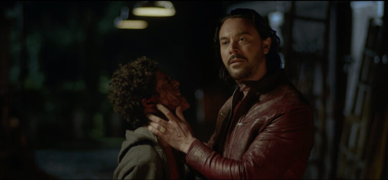 Baal played by Jack Huston holds the bloody face of Benny Emmanuel, playing Jose in Hail Mary.